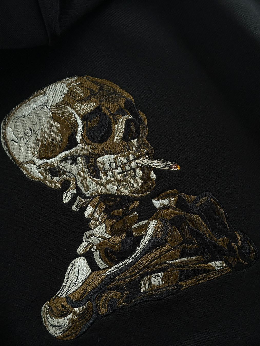 SKULL OF A SKELETON WITH BURNING CIGARETTE