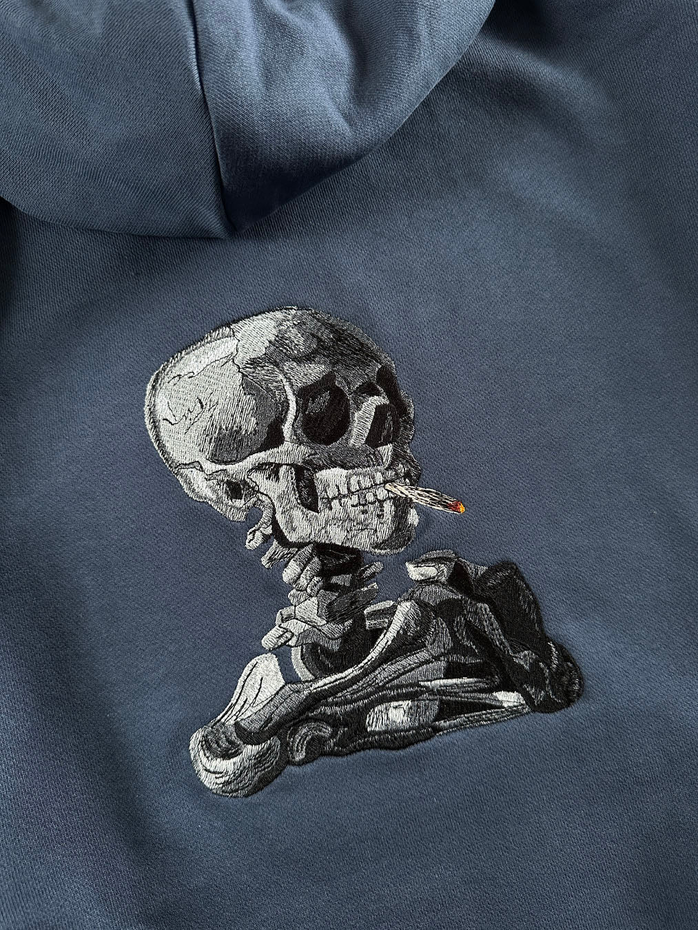 SKULL OF A SKELETON WITH BURNING CIGARETTE