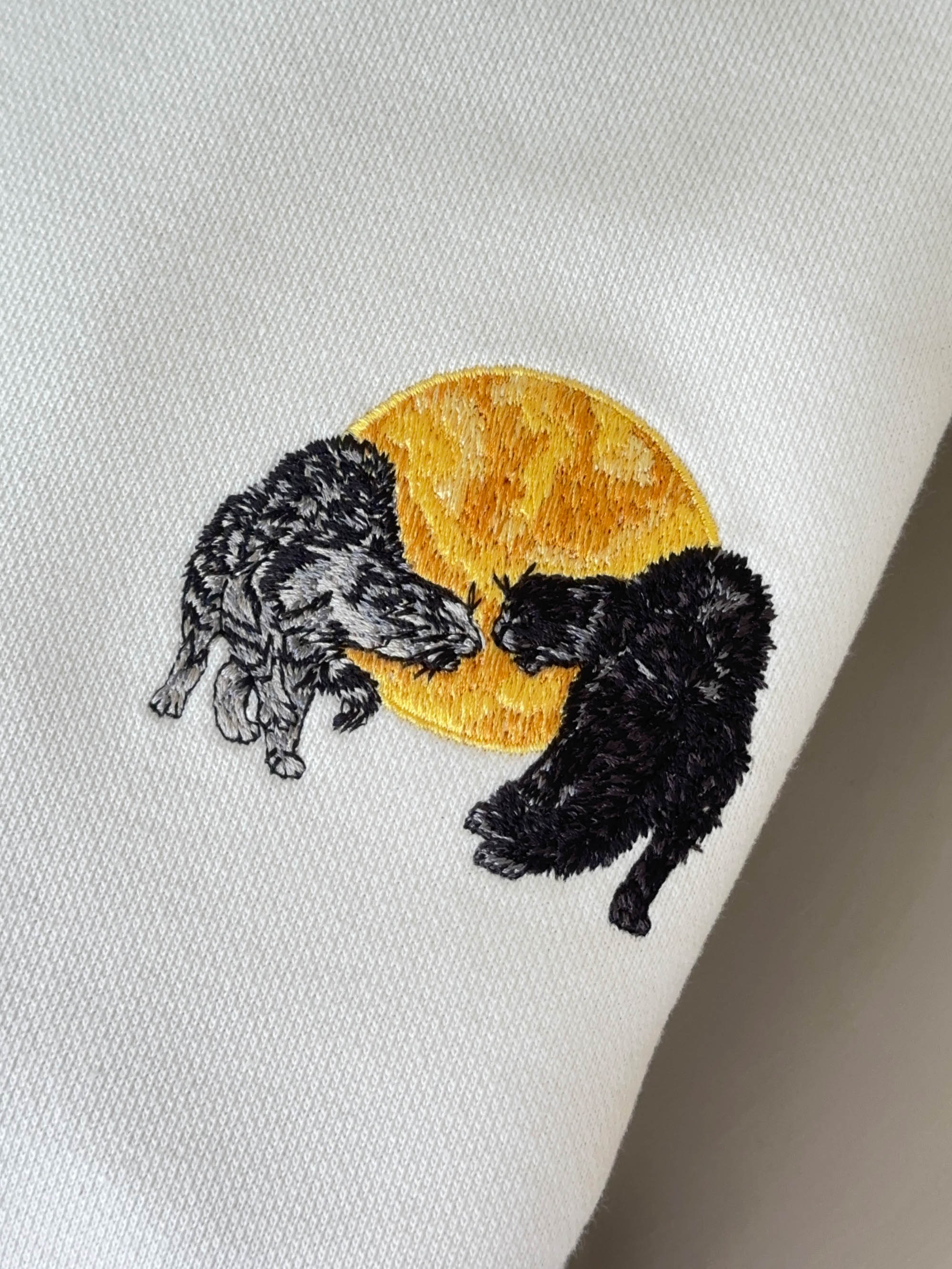 TWO CATS FIGHTING AGAINST THE SILHOUETTE OF THE MOON